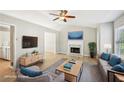 Bright living room features a fireplace, ceiling fan, and comfortable seating at 1900 Foster Trace Ct, Lawrenceville, GA 30043