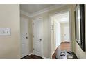 Entryway with neutral paint, dark hardwood floors, white doors, and white trim and access to closets at 311 Peachtree Hills Ne Ave # 17C, Atlanta, GA 30305