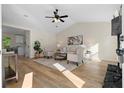 Bright living room with vaulted ceilings, modern furnishings, wood floors and a fireplace at 9347 Haley Ct, Jonesboro, GA 30238