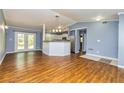 Open-concept living space with hardwood floors, French doors to backyard and convenient kitchen access at 108 Dove, Peachtree City, GA 30269