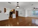 Bright living room featuring hardwood floors and modern lighting fixtures adjacent to the kitchen at 3655 Habersham Ne Rd # B-254, Atlanta, GA 30305