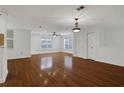 Spacious living area with gleaming hardwood floors, two large windows, and ceiling fan at 3655 Habersham Ne Rd # B-254, Atlanta, GA 30305