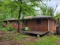 Side view of a brick house with a small deck at 4758 Highway 81, Mcdonough, GA 30252