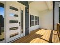 Welcoming front porch with modern door and sidelight, showcasing sleek design and inviting outdoor space at 492 Mary Hill Ln, Douglasville, GA 30134