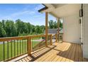 Spacious porch featuring wood flooring and black iron railings, offering a perfect outdoor retreat with serene views at 492 Mary Hill Ln, Douglasville, GA 30134