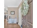 Welcoming entryway with console table, wreath, and wood flooring at 706 Woodland Pl, Woodstock, GA 30188