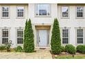 Close-up of the home entrance with mature shrubbery and stone walkway at 300 Radner Run, Lawrenceville, GA 30043