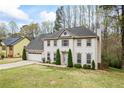 Charming two-story home featuring a manicured front lawn and an attached garage at 300 Radner Run, Lawrenceville, GA 30043