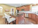 Stylish kitchen with stainless steel appliances, dark wood cabinets, and a large island at 3311 Keenland Rd, Marietta, GA 30062