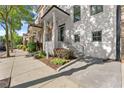 Charming townhome featuring a beautiful garden, steps, and black wrought iron railing at 3932 Boston Common St, Suwanee, GA 30024