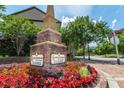 Shadowbrook at Town Center signage surrounded by colorful flowers and greenery at 3932 Boston Common St, Suwanee, GA 30024