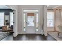 Bright foyer featuring a clear glass front door, with dark wood floors, and elegant trim at 412 Nickajack Retreat Ln, Smyrna, GA 30082