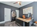 Stylish office with dark gray walls, wood desk, modern decor, and hardwood floors at 412 Nickajack Retreat Ln, Smyrna, GA 30082