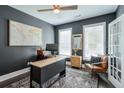 Stylish office with dark walls, a statement rug, a wooden desk and a comfortable leather chair at 412 Nickajack Retreat Ln, Smyrna, GA 30082