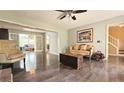 Bright living room featuring hardwood floors, neutral walls, and a classic sofa with a decorative armchair at 1200 Izod Ct, Lawrenceville, GA 30044