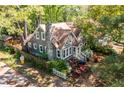 An elevated perspective of a beautiful home showcasing landscaping, fenced yard and stone chimney at 1326 Metropolitan Se Ave, Atlanta, GA 30316
