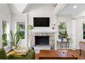 Bright living room featuring a stone fireplace, large windows, and a comfortable green sofa at 1326 Metropolitan Se Ave, Atlanta, GA 30316
