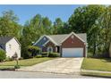 Lovely single-story home with brick accents, complemented by a well-maintained lawn and driveway at 1570 Hill Crossing Ct, Grayson, GA 30017