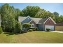 Beautiful home with a lush green lawn and mature trees, offering a peaceful and inviting atmosphere at 1570 Hill Crossing Ct, Grayson, GA 30017