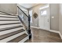 Welcoming entryway featuring hardwood floors, a staircase, and a charming window above the door at 815 Commerce Trl, Canton, GA 30114