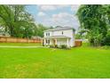 Two-story home boasting a spacious green lawn and a covered porch at 90 Cerro St, Atlanta, GA 30314