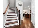 Inviting home staircase featuring hardwood steps and floors plus classic wood banisters and trim at 1427 Lanier Vista Dr, Sugar Hill, GA 30518