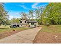 Charming home featuring a well-maintained front yard, long driveway, and ample greenery all around at 2637 Crestdale Se Cir, Atlanta, GA 30316