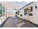 Outdoor kitchen complete with stainless steel grill, granite countertop, lighting, and ceiling fan at 443 Plateau Nw Pl, Atlanta, GA 30309