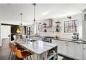 Spacious kitchen with island seating, modern appliances, stone countertops, and updated lighting fixtures at 4568 Oswood Ct, Tucker, GA 30084