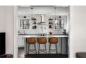 Stylish kitchen featuring a center island with seating, pendant lighting, open shelving, and updated appliances at 4568 Oswood Ct, Tucker, GA 30084