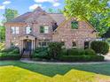Beautiful brick home featuring manicured lawn and landscaping, perfect mix of traditional architecture and curb appeal at 602 Davenport Pl, Canton, GA 30115