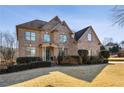 Beautiful two-story brick home with a manicured front yard and classic architectural details at 602 Davenport Pl, Canton, GA 30115