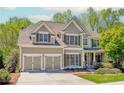 Charming two-story home with a well-manicured lawn, attached two car garage, and mature trees at 4106 Creekview Ridge Ne Dr, Buford, GA 30518