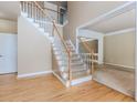 Elegant foyer with hardwood floors, a staircase with carpeted steps, and an open doorway to a carpeted living room at 4106 Creekview Ridge Ne Dr, Buford, GA 30518