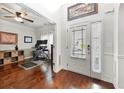 Bright foyer with hardwood floors, a white front door, and an adjacent office space at 3599 Bellmonte Dr, Atlanta, GA 30337