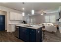 Open-concept kitchen with a center island, modern lighting, and stainless steel appliances at 518 Scenic Pass, Woodstock, GA 30189