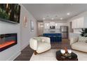 Cozy living room with modern fireplace open to the kitchen at 518 Scenic Pass, Woodstock, GA 30189