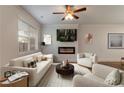 Bright living room with ceiling fan, fireplace, and plush neutral furnishings at 518 Scenic Pass, Woodstock, GA 30189