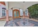 Arched portico entrance featuring marble flooring and detailed architecture at 725 Links View Dr, Sugar Hill, GA 30518