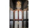 Close-up of the foyer's impressive black marble tile and chandelier at 725 Links View Dr, Sugar Hill, GA 30518