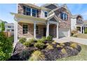 Inviting front porch with decorative columns and manicured landscaping at 1840 Wellston Dr, Lawrenceville, GA 30043