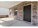 Close-up of the front entrance with a dark-colored door and brick surround at 1840 Wellston Dr, Lawrenceville, GA 30043