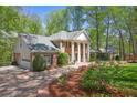 Elegant brick home with manicured landscaping, circular driveway, and attached garage at 2000 Old Dominion Rd, Atlanta, GA 30350