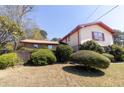 Angled exterior of the home with lush landscaping at 3670 Whirlaway Dr, Decatur, GA 30034