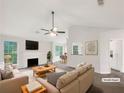 Bright living room with a fireplace, neutral decor, and large windows at 7240 Raintree Loop, Jonesboro, GA 30236