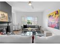 Inviting living room with a cozy fireplace, grey sofa, and bright natural light from the window at 108 Vinings Forest Se Cir, Smyrna, GA 30080