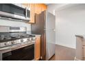 Kitchen with stainless steel oven and refrigerator and wood cabinets with light countertop at 215 Piedmont Ne Ave # 1110, Atlanta, GA 30308