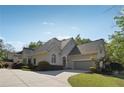 Charming stucco home with a two-car garage, complemented by lush landscaping and a well-maintained lawn at 4310 Wellbrook Ct, Douglasville, GA 30135