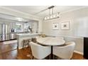 Dining area featuring hardwood floors, a marble table, stylish chairs, and modern lighting at 1226 Haven Brook Ne Way, Brookhaven, GA 30319