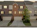 Exterior shot of brick townhomes showcasing the facade and attached garages at 1902 Glen Ivy, Marietta, GA 30062